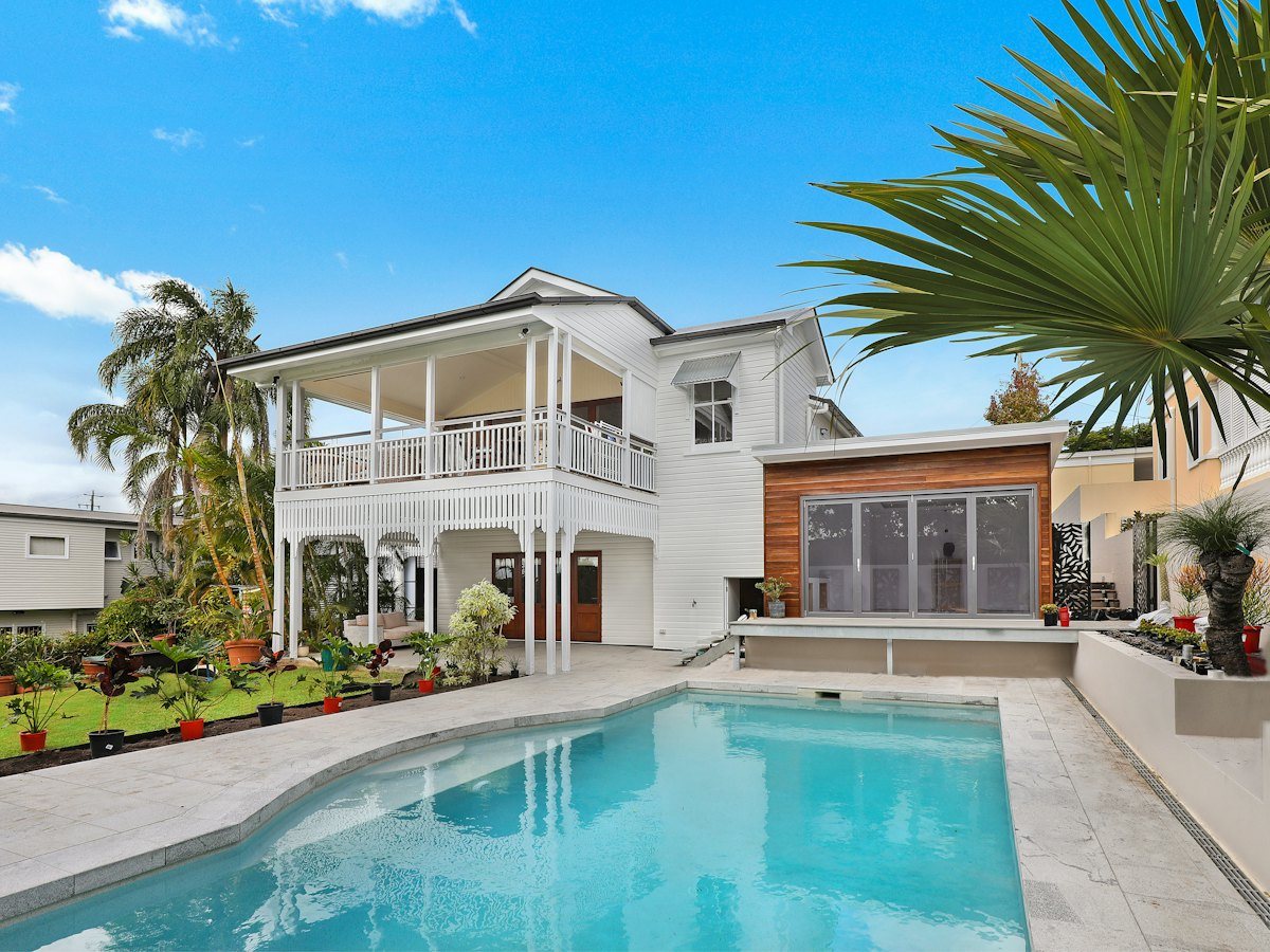 A South Florida home with palms and a pool