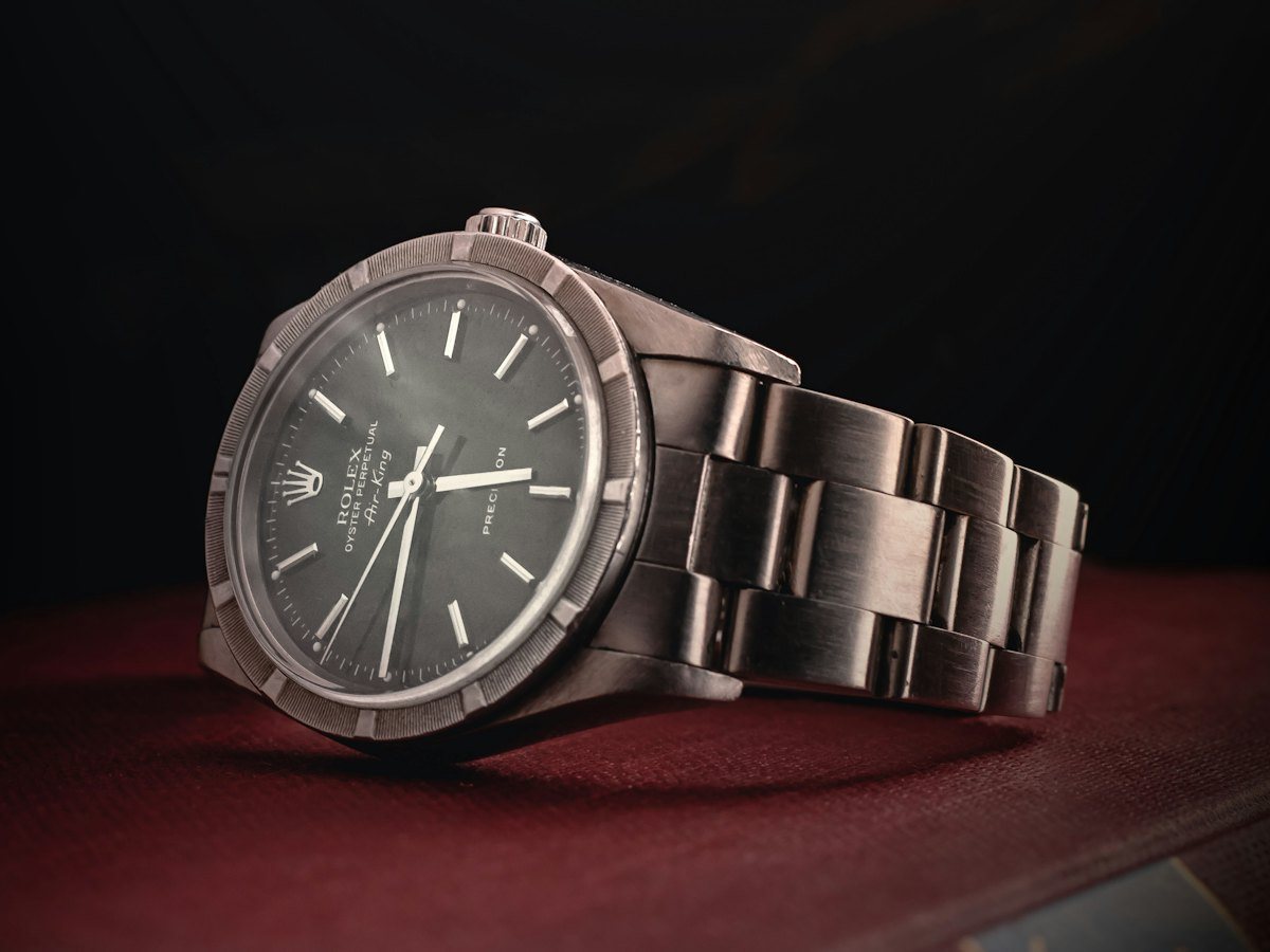 A luxury wristwatch on a dark display