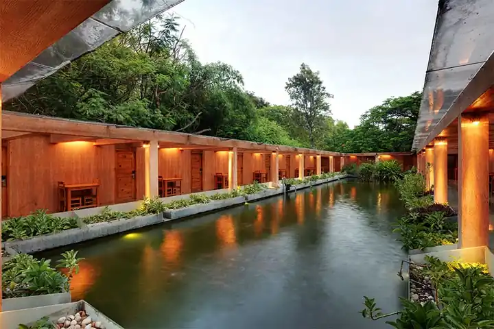 Aqua rooms beside the water court at Gold Coins Club & Resort at dusk